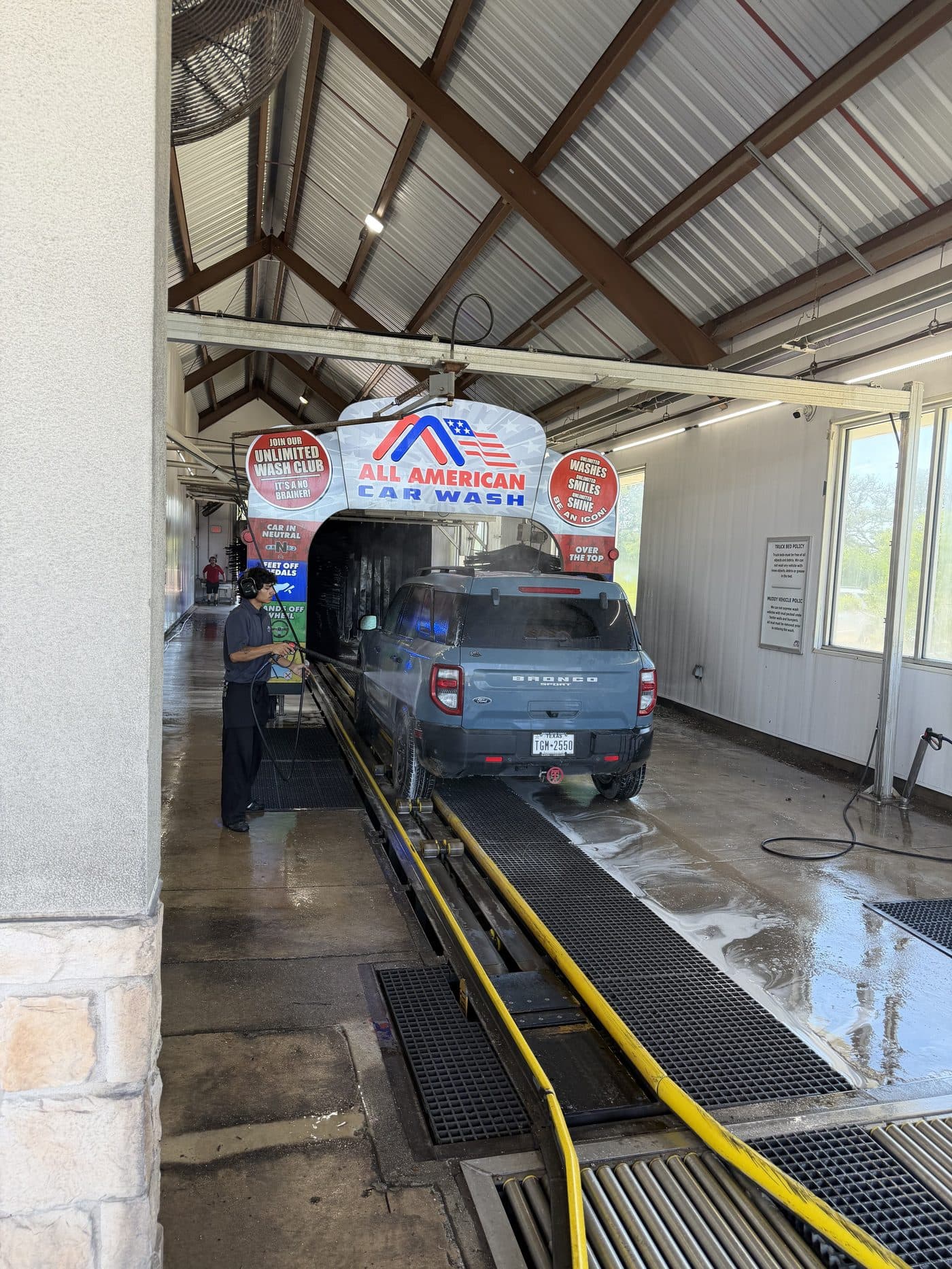A vehicle entering the All American Car Wash express tunnel